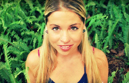 Debby Carrigan surrounded by green foliage