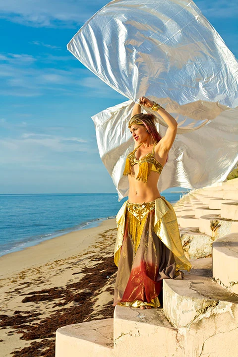 Debby moving with flowing silk wings on a beach